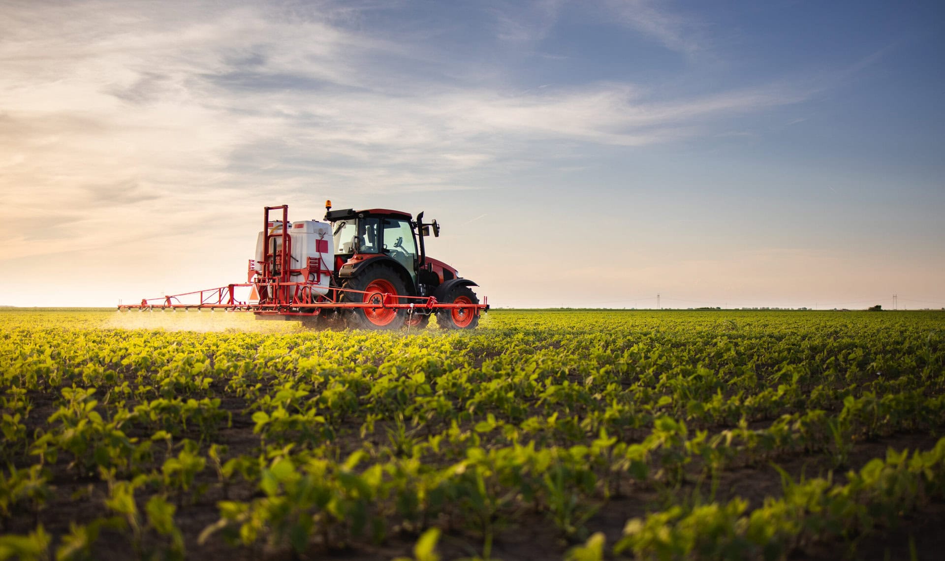 tractor spraying pesticides soybean field